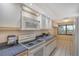Kitchen features white cabinets and a gas cooktop at 5911 Midnight Pass Rd # 504, Sarasota, FL 34242