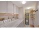 Laundry room with washer, dryer, and extra storage at 5911 Midnight Pass Rd # 504, Sarasota, FL 34242