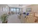 Living room with water views, comfy seating, and balcony access at 5911 Midnight Pass Rd # 504, Sarasota, FL 34242
