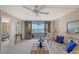Living room with striped couches, water views, and balcony access at 5911 Midnight Pass Rd # 504, Sarasota, FL 34242