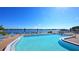 Inviting community pool with lounge chairs and waterfront views at 5911 Midnight Pass Rd # 504, Sarasota, FL 34242