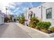 White stucco building with Spanish-style architecture, lush landscaping, and a walkway at 635 S Orange Ave # 201, Sarasota, FL 34236