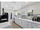 Modern white kitchen with stainless steel appliances and a view of the backyard at 6409 16Th Avenue Dr W, Bradenton, FL 34209