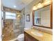Bathroom with walk-in shower and granite vanity at 6620 Pineview Ter, Bradenton, FL 34203