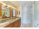 Double vanity bathroom with granite countertops and wood cabinets at 6620 Pineview Ter, Bradenton, FL 34203