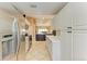 Long kitchen with stainless steel appliances and white cabinets at 6620 Pineview Ter, Bradenton, FL 34203