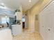 Kitchen with white cabinets and access to other rooms at 6620 Pineview Ter, Bradenton, FL 34203