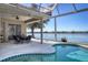 Inviting pool area with lake views and screened lanai at 6630 Windjammer Pl, Lakewood Ranch, FL 34202