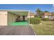Covered carport with green flooring and lush landscaping at 665 Park Cir # 58, Bradenton, FL 34207