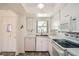 White kitchen with stainless steel appliances and view to entry at 665 Park Cir # 58, Bradenton, FL 34207
