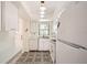 Bright eat-in kitchen features white cabinetry, patterned flooring and updated appliances at 665 Park Cir # 58, Bradenton, FL 34207