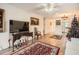 Hardwood floor living room features a large TV, comfy seating and Christmas tree at 665 Park Cir # 58, Bradenton, FL 34207