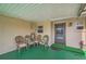 Covered patio with wicker chairs and green flooring at 665 Park Cir # 58, Bradenton, FL 34207