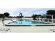 Community pool with surrounding patio furniture at 665 Park Cir # 58, Bradenton, FL 34207