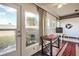 Sunroom with multiple windows, wood flooring, and access to backyard at 665 Park Cir # 58, Bradenton, FL 34207