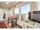 Sunroom with wood flooring, and access to backyard and additional rooms at 665 Park Cir # 58, Bradenton, FL 34207
