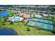 Community pool, tennis, and pickleball courts with lake view at 6870 Willowshire Way, Bradenton, FL 34212