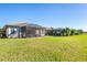 Large backyard with grassy area and screened patio at 6870 Willowshire Way, Bradenton, FL 34212