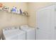 Laundry room with washer, dryer, and ample storage shelving at 6870 Willowshire Way, Bradenton, FL 34212