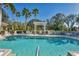 Sparkling community pool with pergola and lounge chairs at 7074 Woodmore Ter, Lakewood Ranch, FL 34202