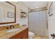 Clean bathroom with granite countertop, wooden vanity, and shower at 7104 9Th Avenue Nw Dr, Bradenton, FL 34209