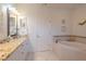 Elegant bathroom with granite countertops, a soaking tub, and a separate shower at 796 Jacaranda Rd, Anna Maria, FL 34216