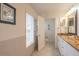 Well-lit bathroom with granite countertops, a sink, and a toilet at 796 Jacaranda Rd, Anna Maria, FL 34216