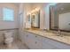 Clean bathroom with granite countertops, double sinks, and a toilet at 796 Jacaranda Rd, Anna Maria, FL 34216