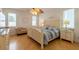 Spacious bedroom with light wood floors, a large bed, and plenty of natural light at 796 Jacaranda Rd, Anna Maria, FL 34216
