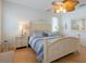 Main bedroom with a light-toned wooden bed frame and blue bedding at 796 Jacaranda Rd, Anna Maria, FL 34216