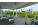 Relaxing outdoor deck with sectional sofa and tropical views at 796 Jacaranda Rd, Anna Maria, FL 34216