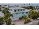 Three-story light blue home with three-car garage at 796 Jacaranda Rd, Anna Maria, FL 34216