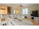 Bright living room featuring a large sectional sofa, coffee table, and flat-screen TV at 796 Jacaranda Rd, Anna Maria, FL 34216