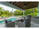 Outdoor kitchen, pool, and lounge seating create an entertainer's paradise at 796 Jacaranda Rd, Anna Maria, FL 34216
