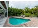 Inviting pool area with lounge chairs and brick pavers at 796 Jacaranda Rd, Anna Maria, FL 34216