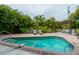 Inviting kidney-shaped pool with ample lounge chairs at 796 Jacaranda Rd, Anna Maria, FL 34216
