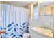 Clean bathroom with shower/tub combo and a fish-themed curtain at 801 Church St, Nokomis, FL 34275