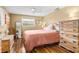Comfortable bedroom with king-size bed, dresser and wood floors at 801 Church St, Nokomis, FL 34275