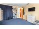 Bright bedroom with double bed and dresser, access to another room at 801 Church St, Nokomis, FL 34275