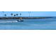 Boat in the water near a shoreline with people at 801 Church St, Nokomis, FL 34275