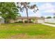Single-story home with a spacious lawn and attached garage at 801 Church St, Nokomis, FL 34275