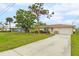 House exterior showcasing a well-maintained yard and driveway at 801 Church St, Nokomis, FL 34275