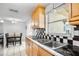 Bright kitchen features wood cabinets, black and white tile, and a dining area at 801 Church St, Nokomis, FL 34275