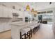 Modern kitchen with white cabinets, island seating, and breakfast nook at 8358 Redonda Loop, Bradenton, FL 34202