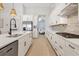 Modern kitchen with white cabinets, quartz countertops, and breakfast bar at 8358 Redonda Loop, Bradenton, FL 34202