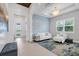 Light and airy sitting area, featuring a white sofa and blue accent wall at 8358 Redonda Loop, Bradenton, FL 34202