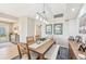 Bright dining room features a wood table, bench seating, and a modern light fixture at 8402 Grand Estuary Trl # 104, Bradenton, FL 34212