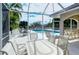 Enjoy relaxing poolside with patio furniture under the screened enclosure at 9620 Club South Cir # 5209, Sarasota, FL 34238