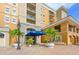 Condo building entrance with landscaping and a covered area at 1064 N Tamiami Trl # 1218, Sarasota, FL 34236