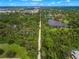 Aerial view of a long trail through lush green landscape at 1109 Scherer Way, Osprey, FL 34229